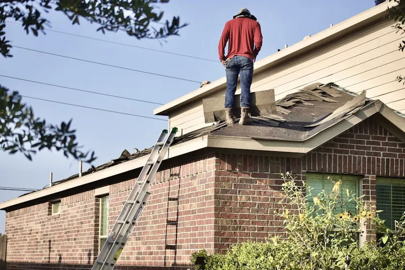 Professional roofer working on a residential roof in Winchester Town Center